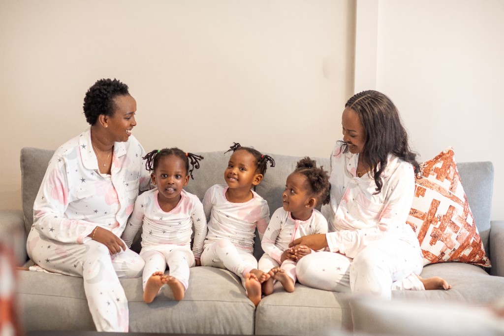Moms and children wearing matching Snuggle Bestie pajamas